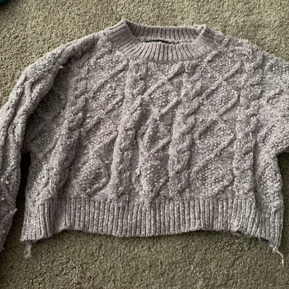 A grey cropped sweater